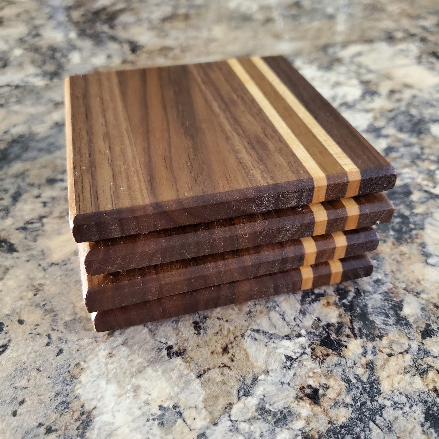 Classic coasters, made of primarily walnut with two maple stripes