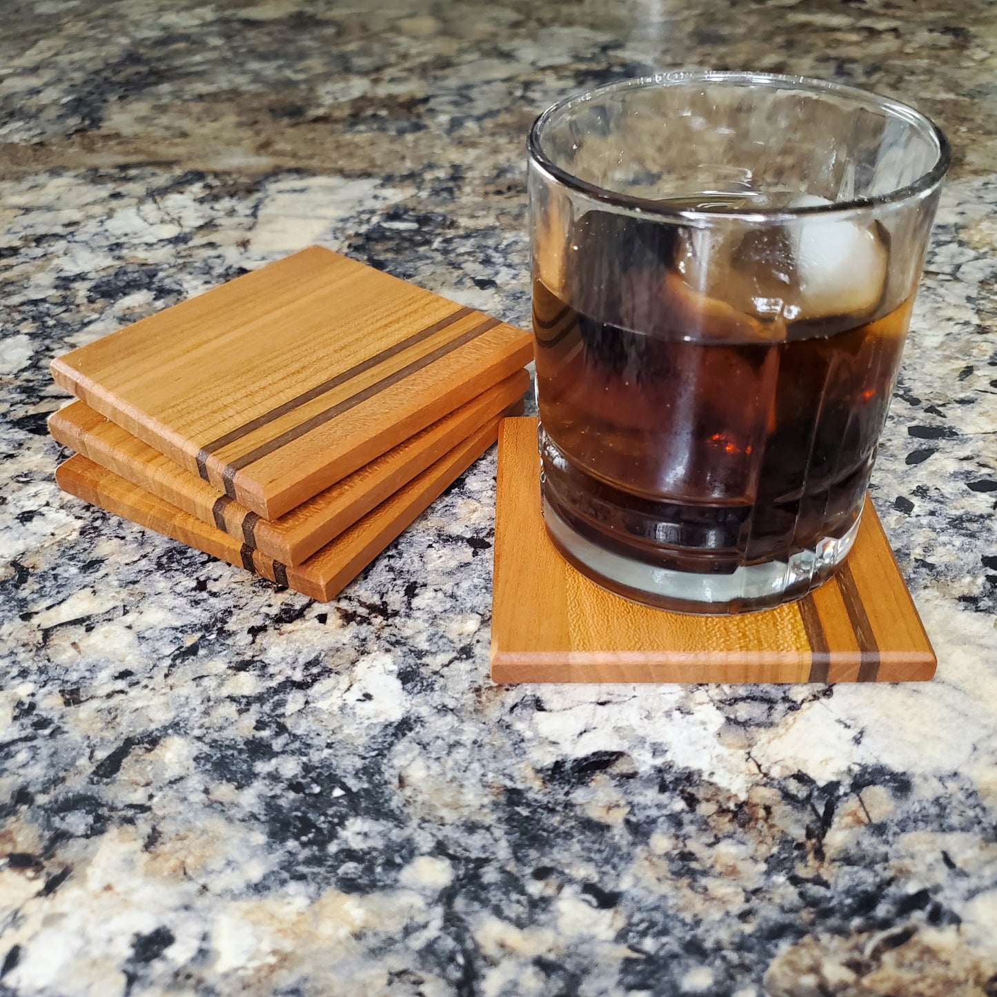 Classic coasters, made of primarily cherry with two walnut stripes by Lone Wolf Wood Designs