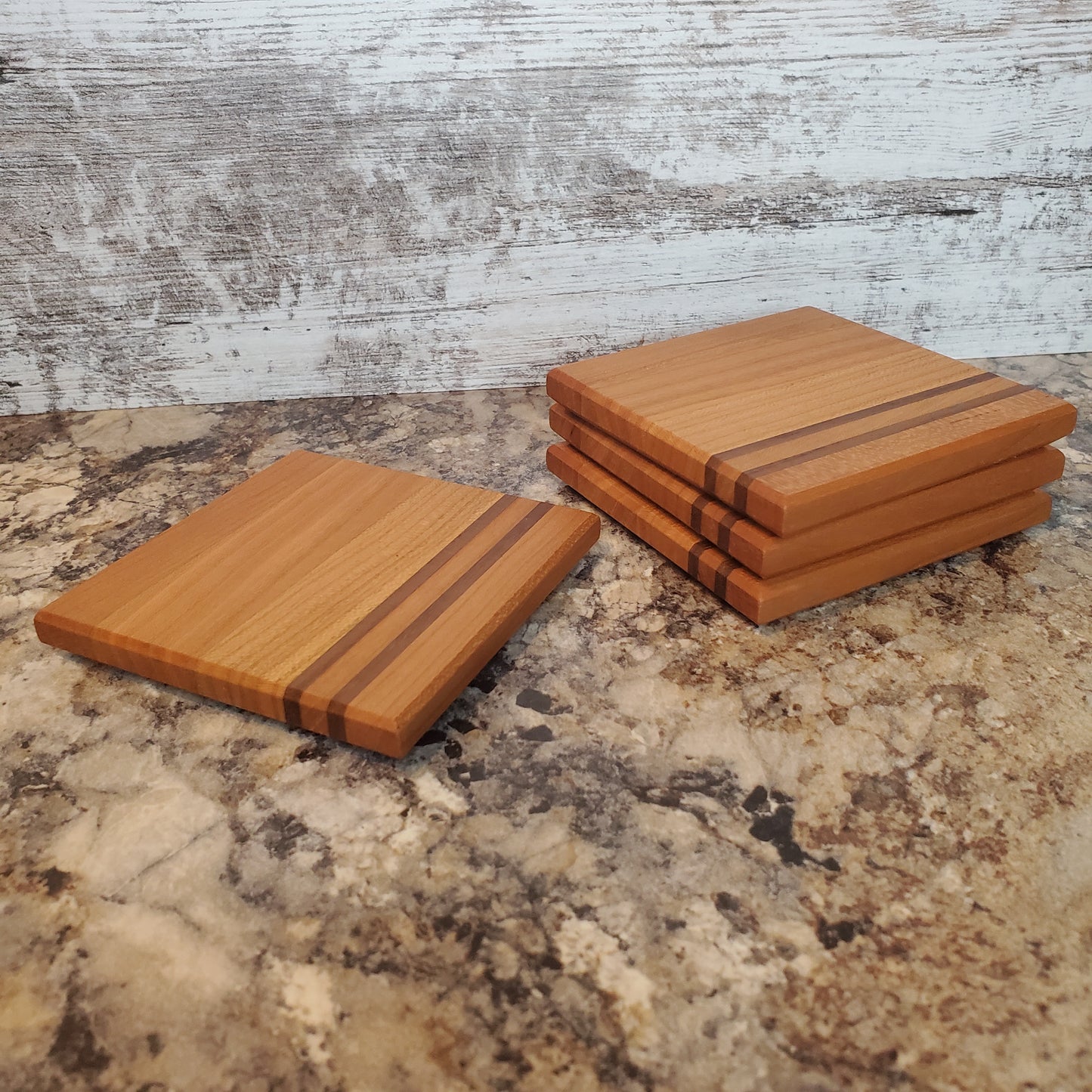 Classic coasters, made of primarily cherry with two walnut stripes by Lone Wolf Wood Designs