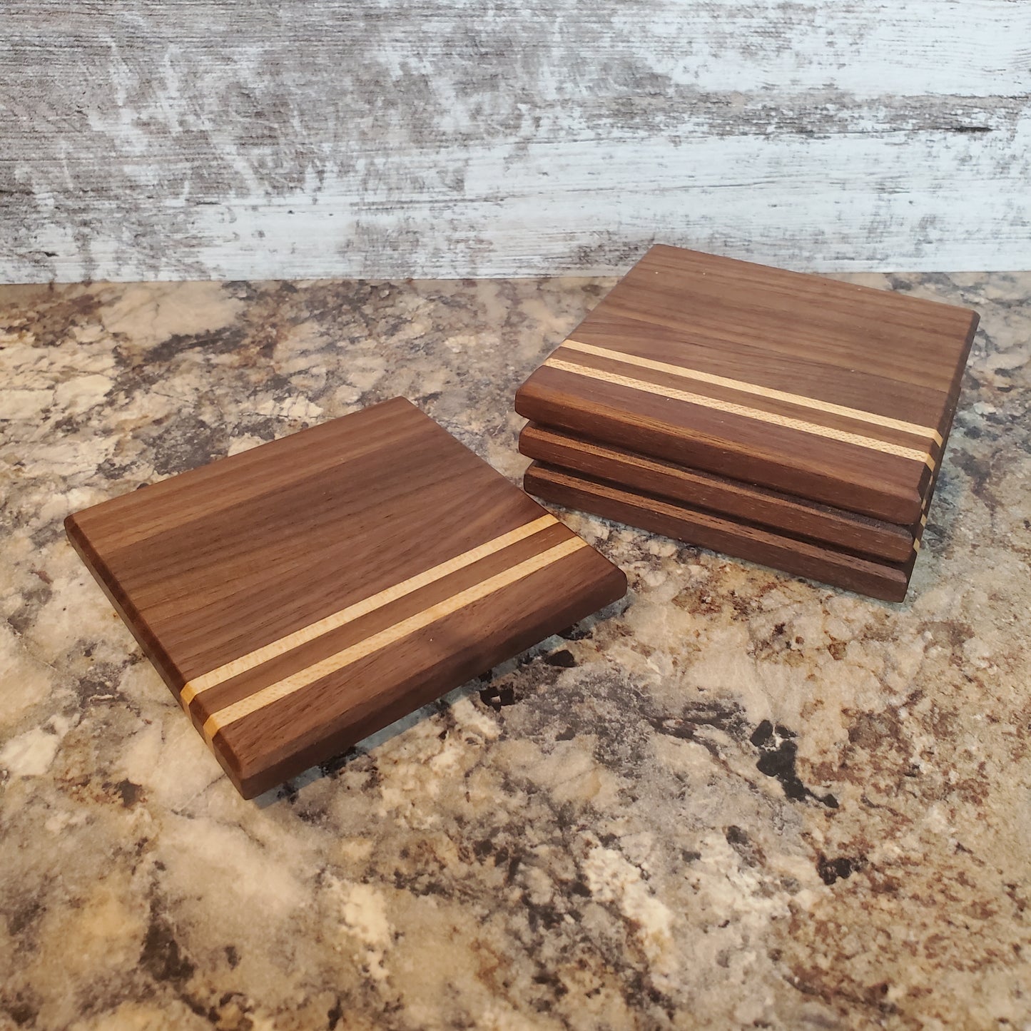 Classic coasters, made of primarily walnut with two maple stripes