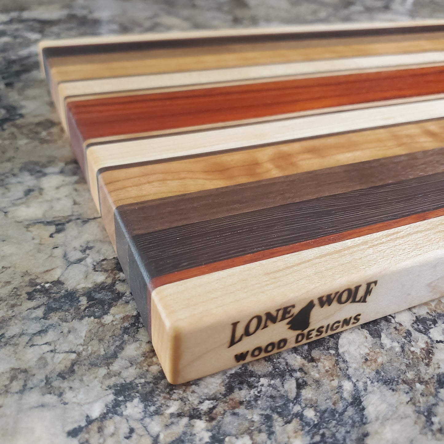 Signature Series Monarch cutting board made from maple, cherry, walnut, wenge and padauk by Lone Wolf Wood Designs