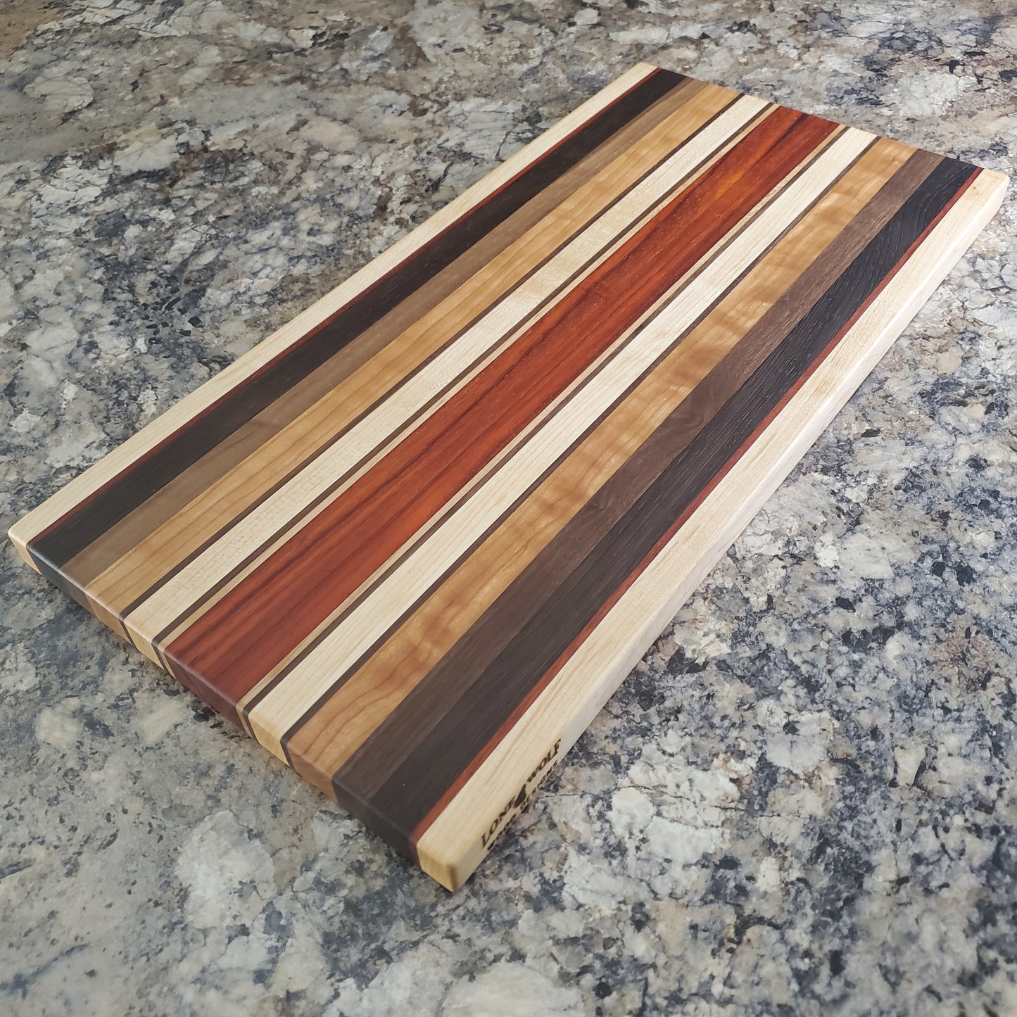 Signature Series Monarch cutting board made from maple, cherry, walnut, wenge and padauk by Lone Wolf Wood Designs