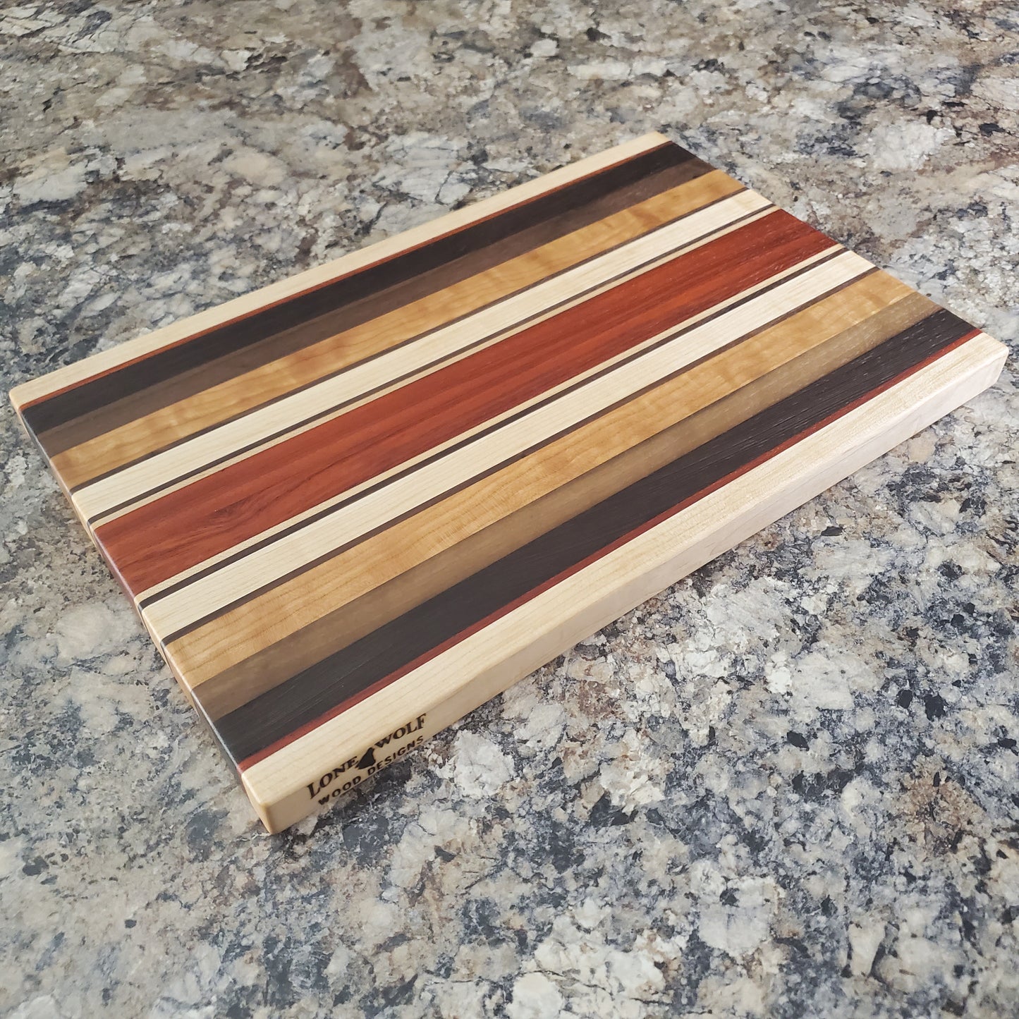 Signature Series Monarch cutting board made from maple, cherry, walnut, wenge and padauk by Lone Wolf Wood Designs