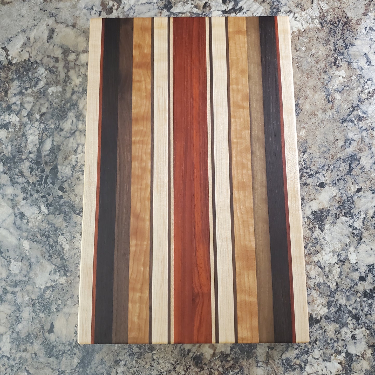 Signature Series Monarch cutting board made from maple, cherry, walnut, wenge and padauk by Lone Wolf Wood Designs