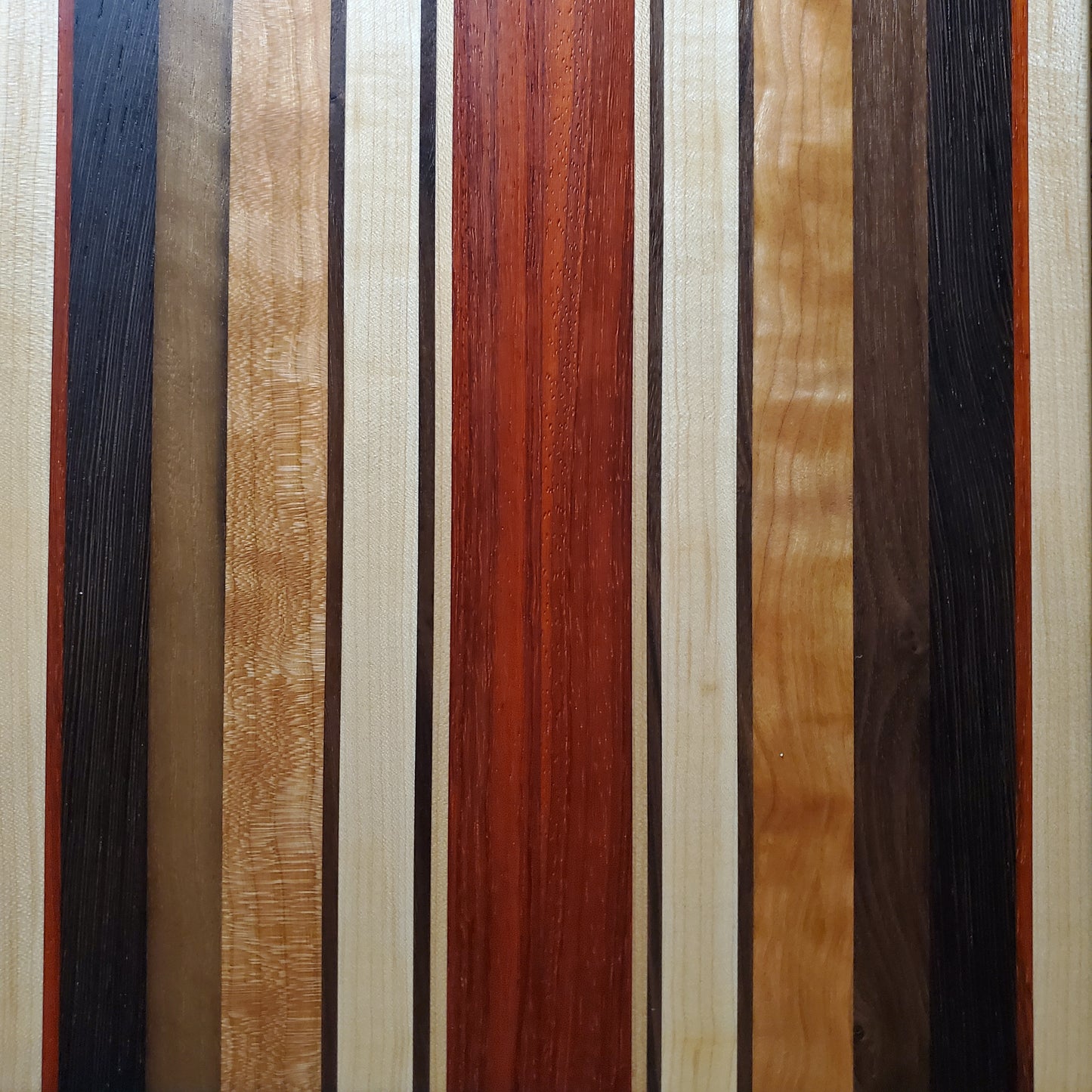 Signature Series Monarch cutting board made from maple, cherry, walnut, wenge and padauk by Lone Wolf Wood Designs