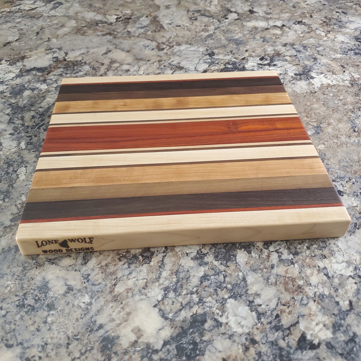 Signature Series Monarch cutting board made from maple, cherry, walnut, wenge and padauk by Lone Wolf Wood Designs