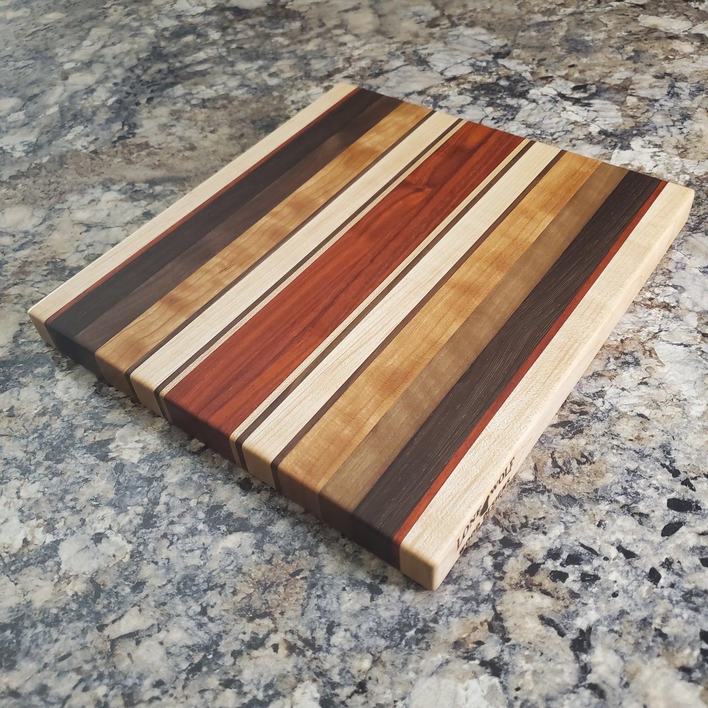 Signature Series Monarch cutting board made from maple, cherry, walnut, wenge and padauk by Lone Wolf Wood Designs