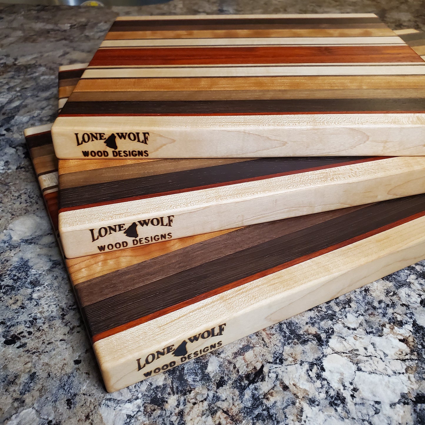 Signature Series Monarch cutting board made from maple, cherry, walnut, wenge and padauk by Lone Wolf Wood Designs