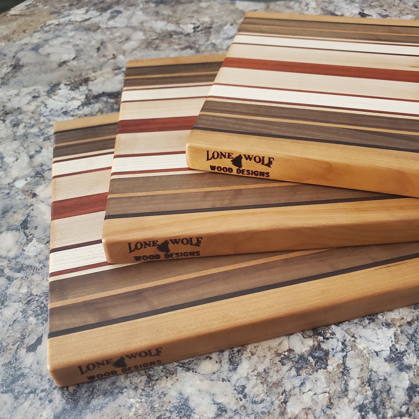 Signature Series Pumpkin Spice cutting board made from maple, walnut, cherry, padauk, and wenge by Lone Wolf Wood Designs