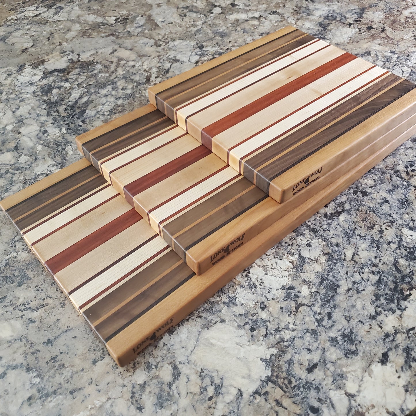 Signature Series Pumpkin Spice cutting board made from maple, walnut, cherry, padauk, and wenge by Lone Wolf Wood Designs