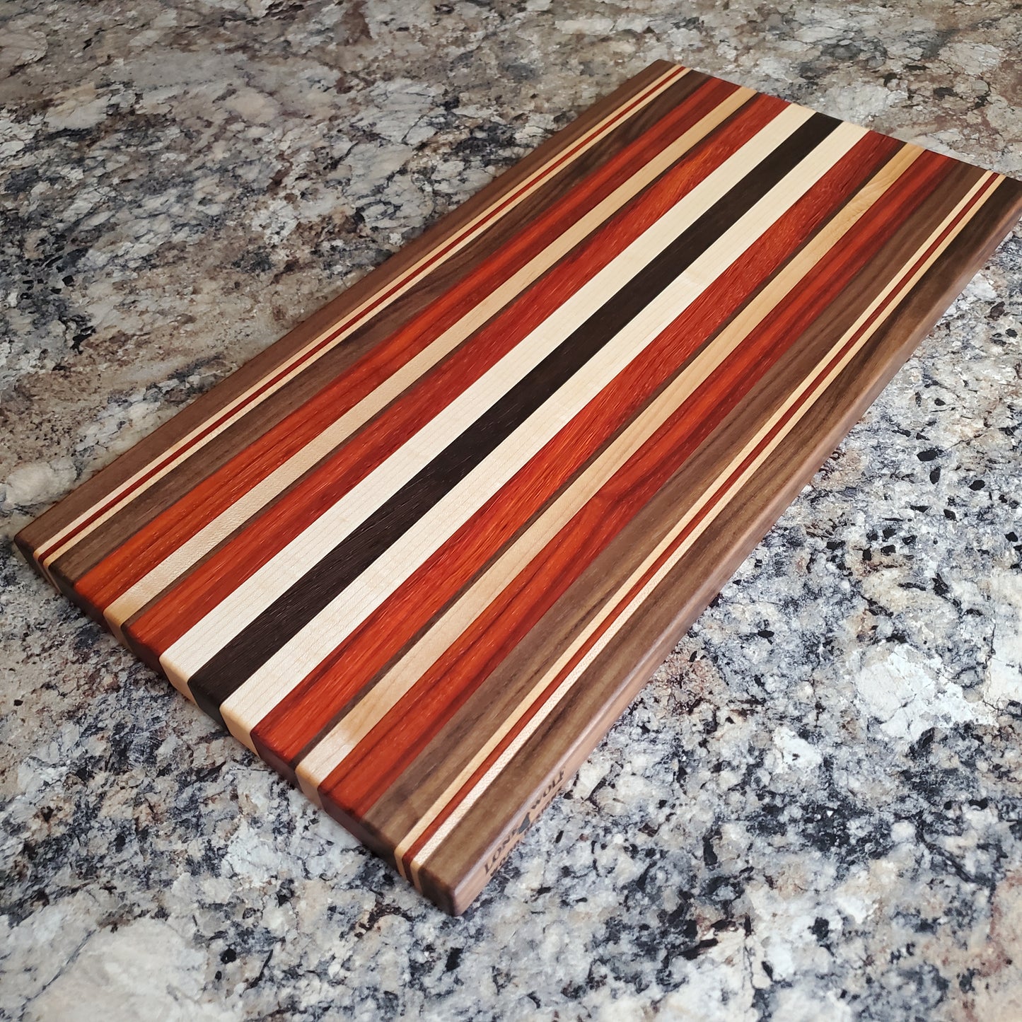 Signature Series October Fest cutting board made from maple, walnut, padauk, and wenge by Lone Wolf Wood Designs