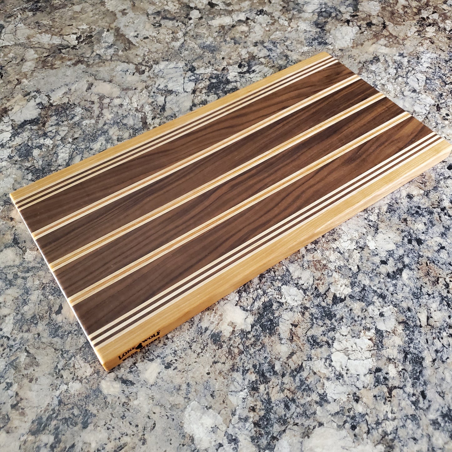 Signature Series Rushmore cutting board made from maple, walnut, and cherry by Lone Wolf Wood Designs