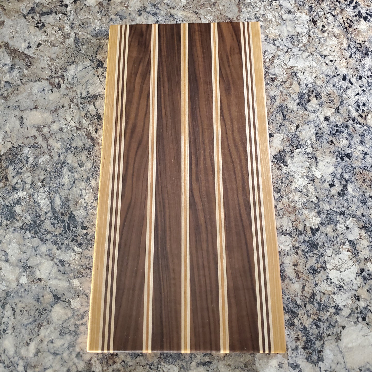 Signature Series Rushmore cutting board made from maple, walnut, and cherry by Lone Wolf Wood Designs