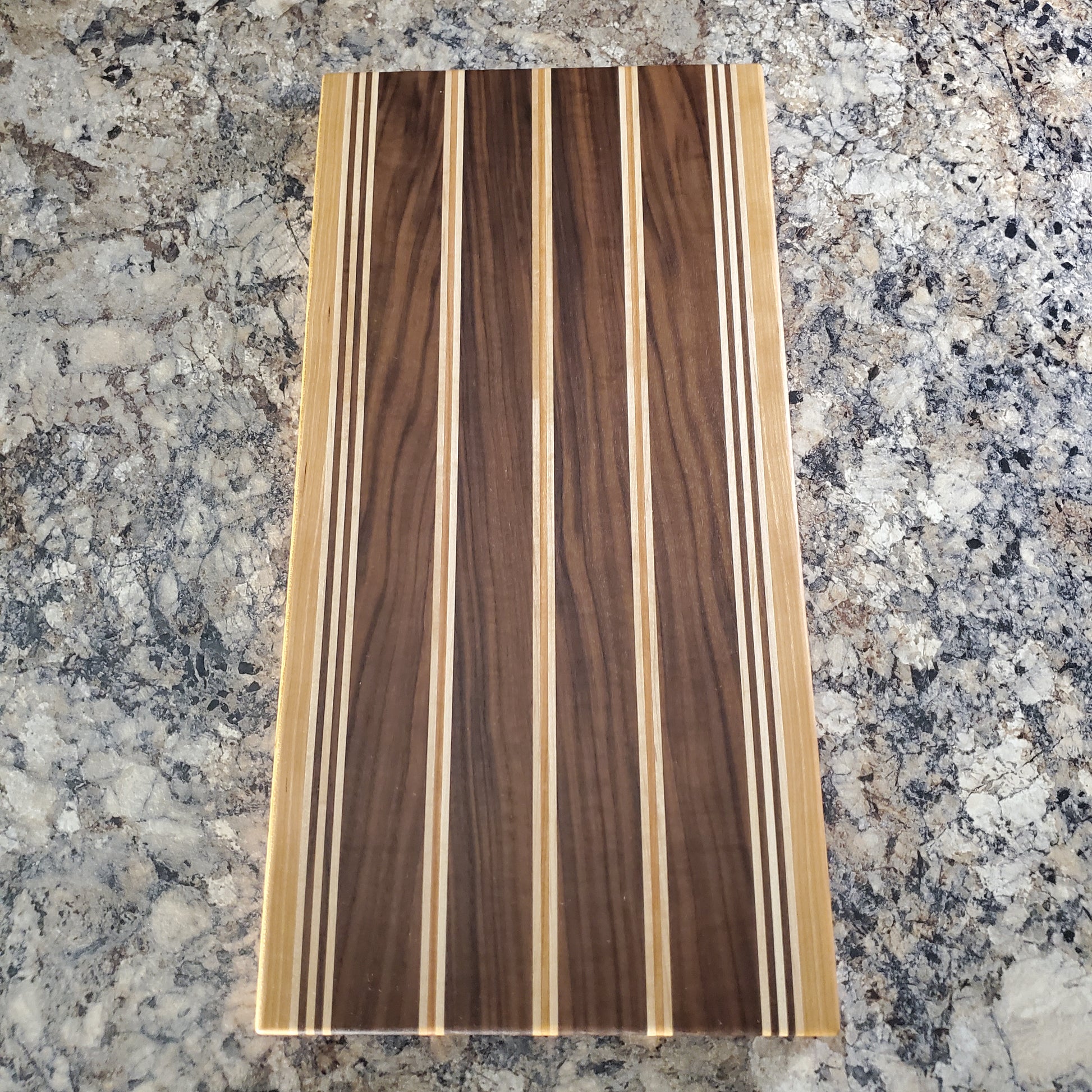 Signature Series Rushmore cutting board made from maple, walnut, and cherry by Lone Wolf Wood Designs