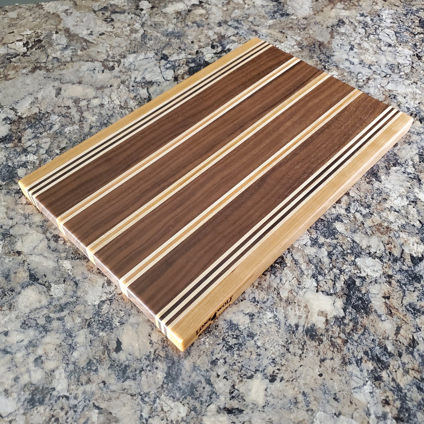 Signature Series Rushmore cutting board made from maple, walnut, and cherry by Lone Wolf Wood Designs