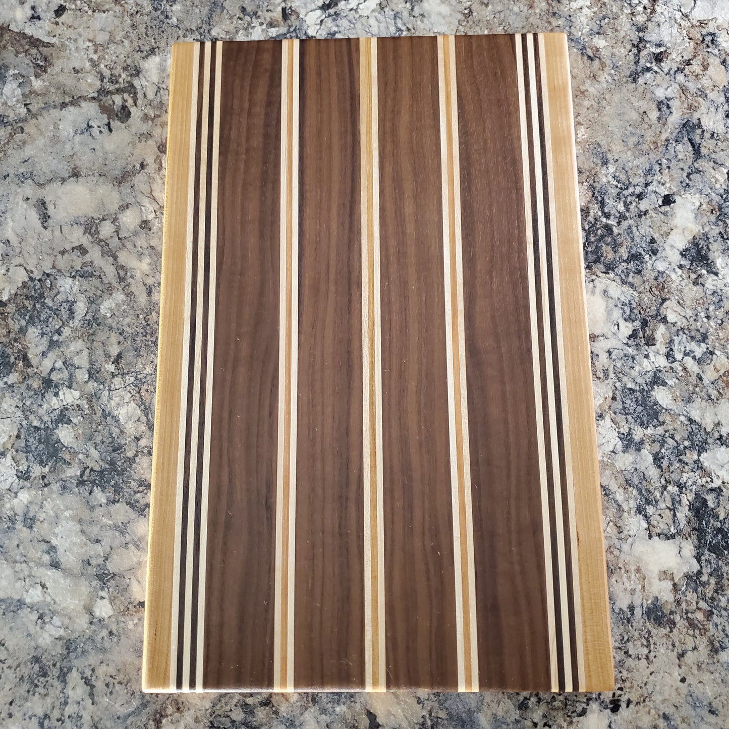 Signature Series Rushmore cutting board made from maple, walnut, and cherry by Lone Wolf Wood Designs