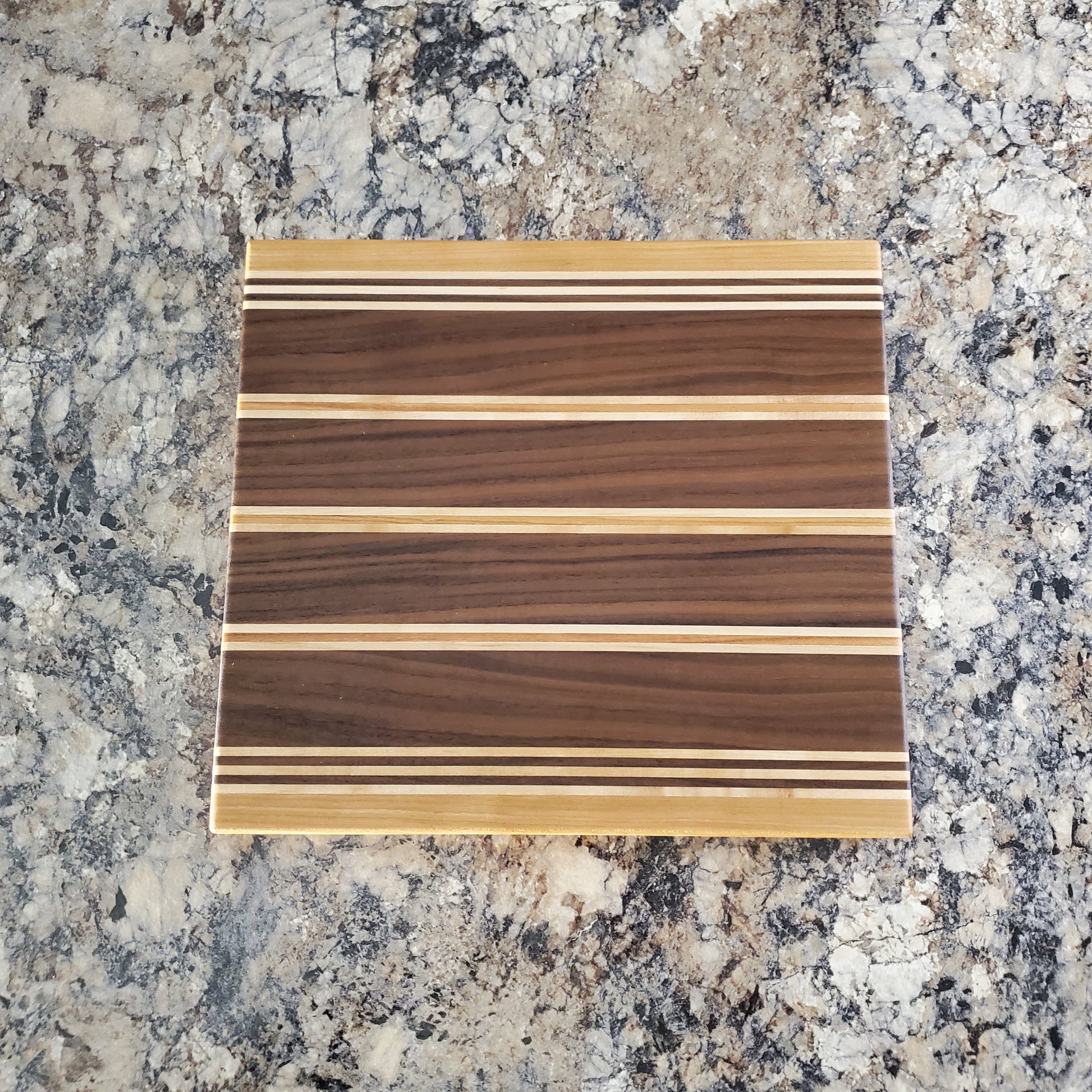 Signature Series Rushmore cutting board made from maple, walnut, and cherry by Lone Wolf Wood Designs