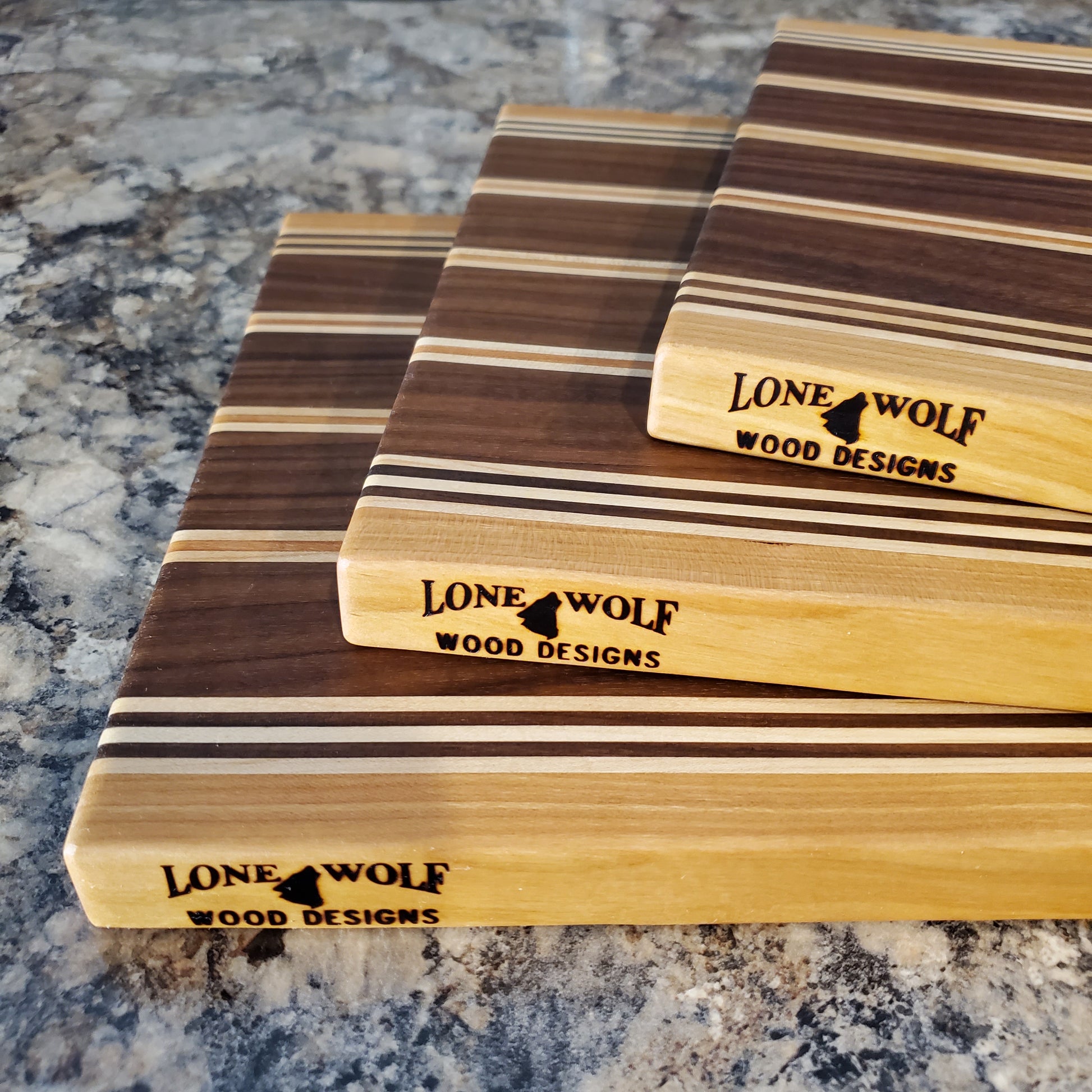 Signature Series Rushmore cutting board made from maple, walnut, and cherry by Lone Wolf Wood Designs